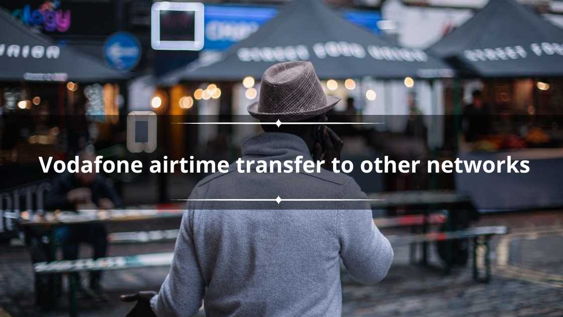 A man with his back facing the camera talking on the phone A man with his back facing the camera talking on the phone