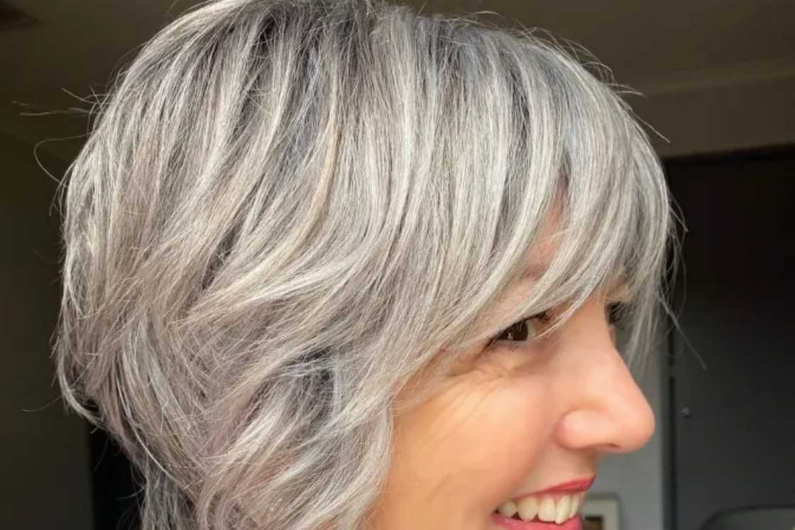 A happy woman rocks a silver blonde bixie shag A happy woman rocks a silver blonde bixie shag