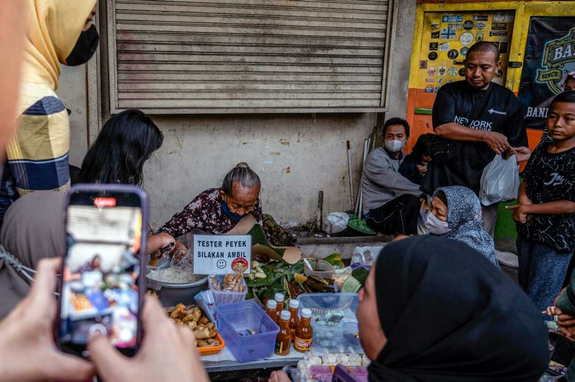 Customers at 76-year-old Mbah Satinem's stall often use their smartphones to capture her at work Customers at 76-year-old Mbah Satinem's stall often use their smartphones to capture her at work