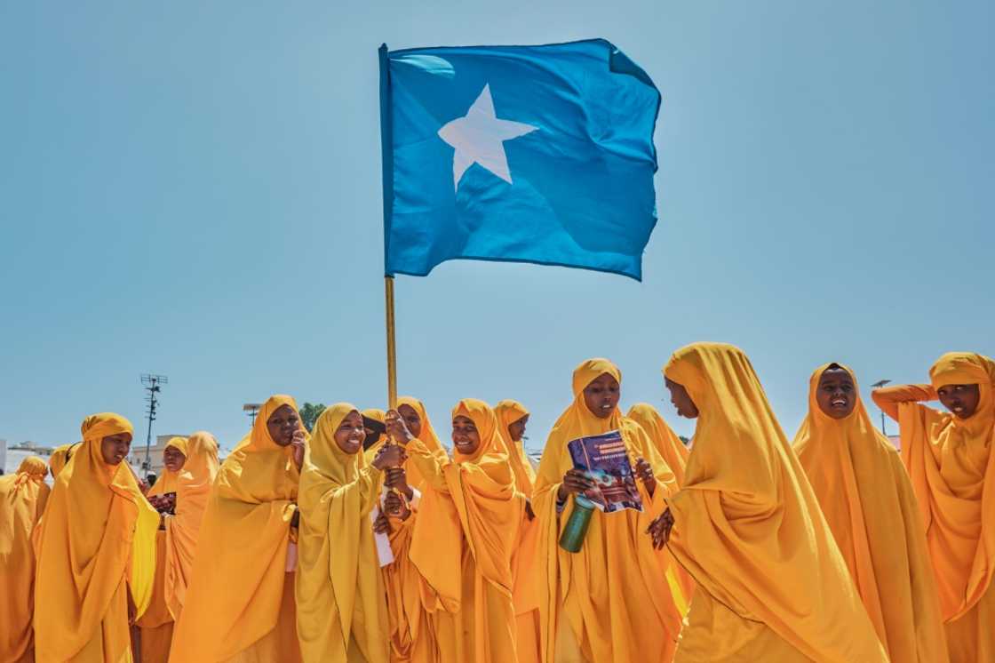 Students wave a Somali flag during a demonstration in support of the government over the controversial deal between Ethiopia and the breakaway region of Somaliland