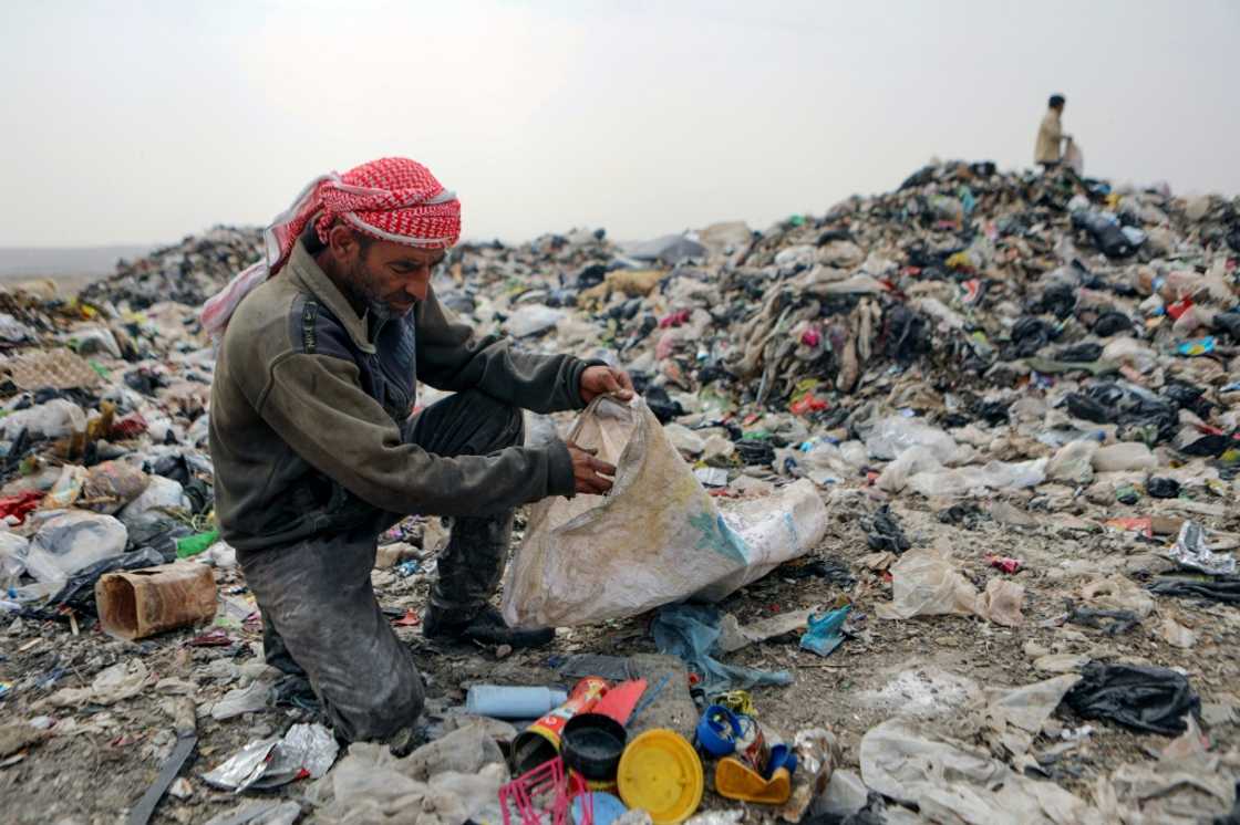 Abu Mohammed sifts through rubbish at a dump near the village of Hazreh Abu Mohammed sifts through rubbish at a dump near the village of Hazreh