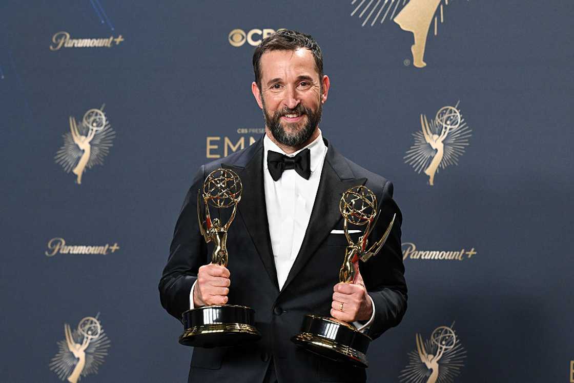 Noah Wyle poses with his awards at the 77th Primetime Emmy Awards.
