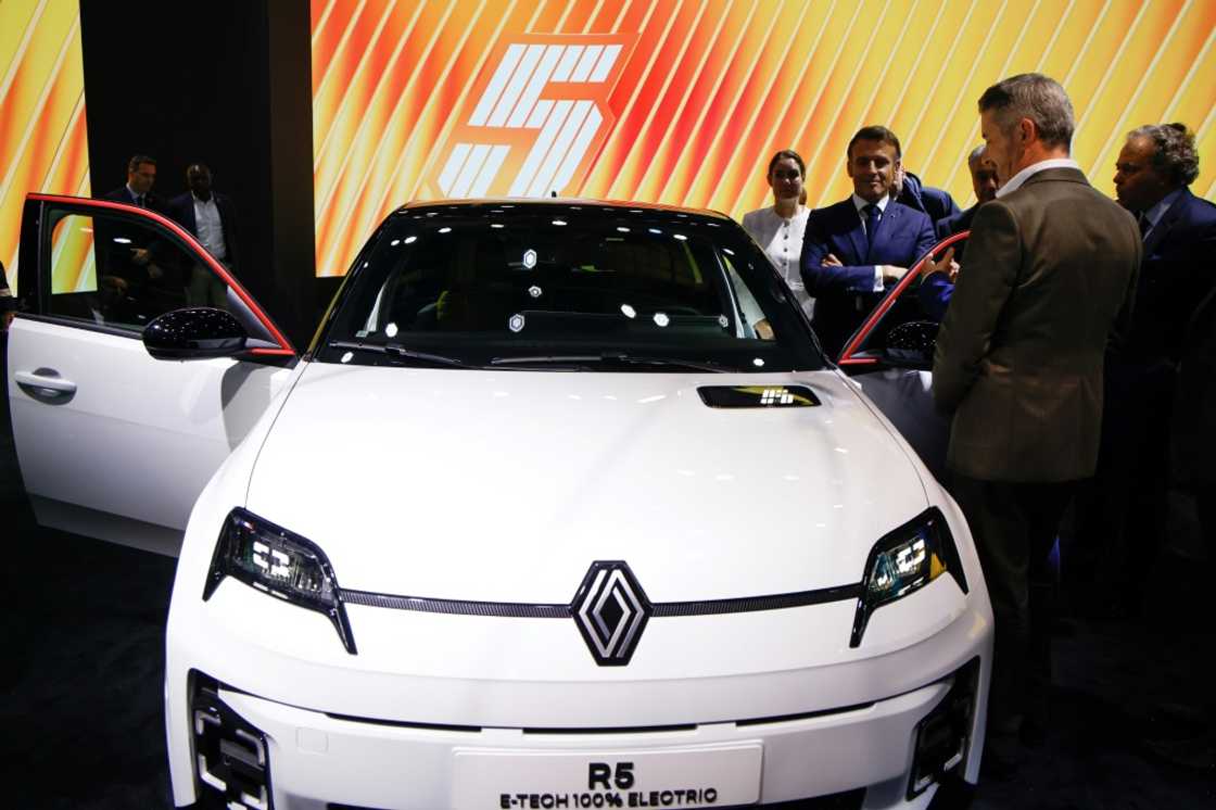 French President Emmanuel Macron stands by a new electric Renault R5 E-Tech at the Paris Motor Show French President Emmanuel Macron stands by a new electric Renault R5 E-Tech at the Paris Motor Show