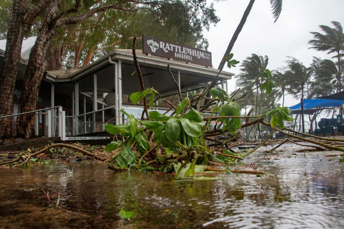 A bar restaurant is seen past fallen branches in Palm Cove as Cyclone Jasper approaches landfall near Cairns in far north Queensland on December 13, 2023. A bar restaurant is seen past fallen branches in Palm Cove as Cyclone Jasper approaches landfall near Cairns in far north Queensland on December 13, 2023.