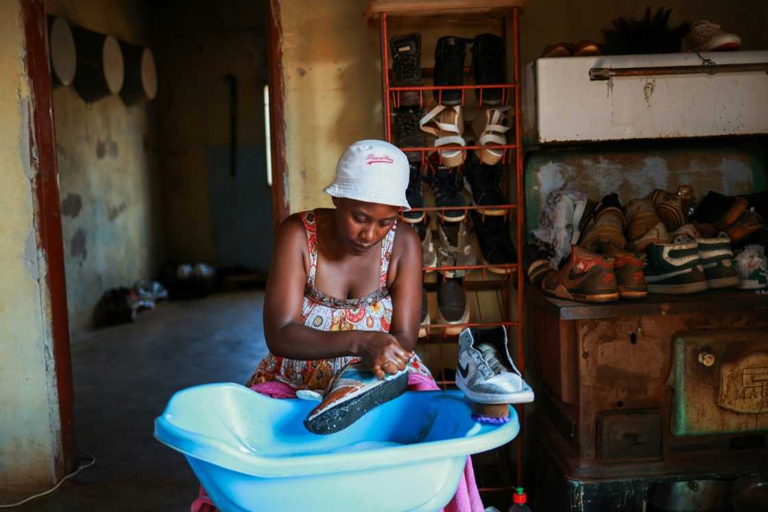 Sneaker cleaner Nhlanhla Vilakazi washes shoes at a backyard workshop to make a living Sneaker cleaner Nhlanhla Vilakazi washes shoes at a backyard workshop to make a living