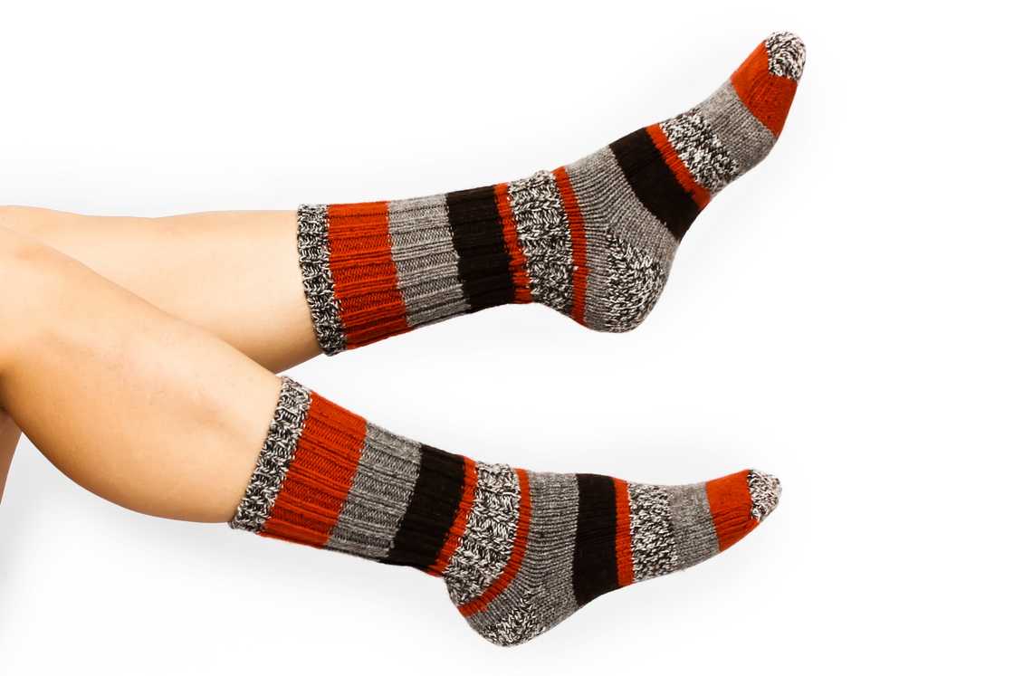 A woman with grey, black, and red crew socks A woman with grey, black, and red crew socks