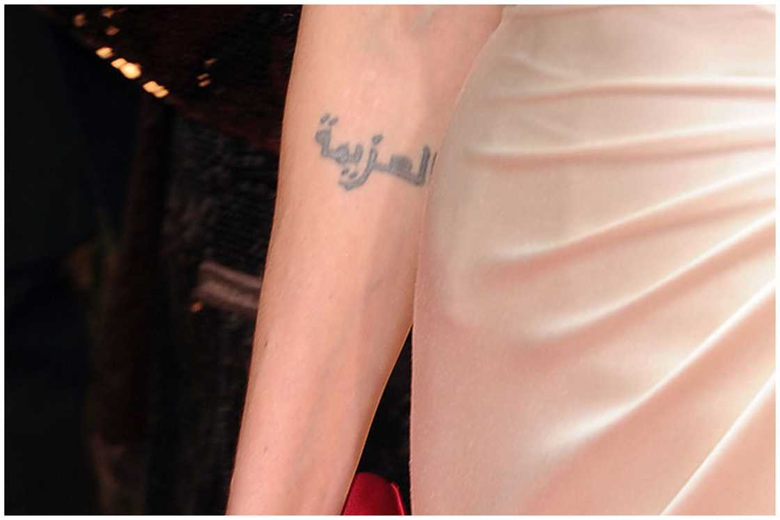 Actress Angelina Jolie's Arabic tattoo as she arrives at the 69th Annual Golden Globe Awards held at the Beverly Hilton Hotel