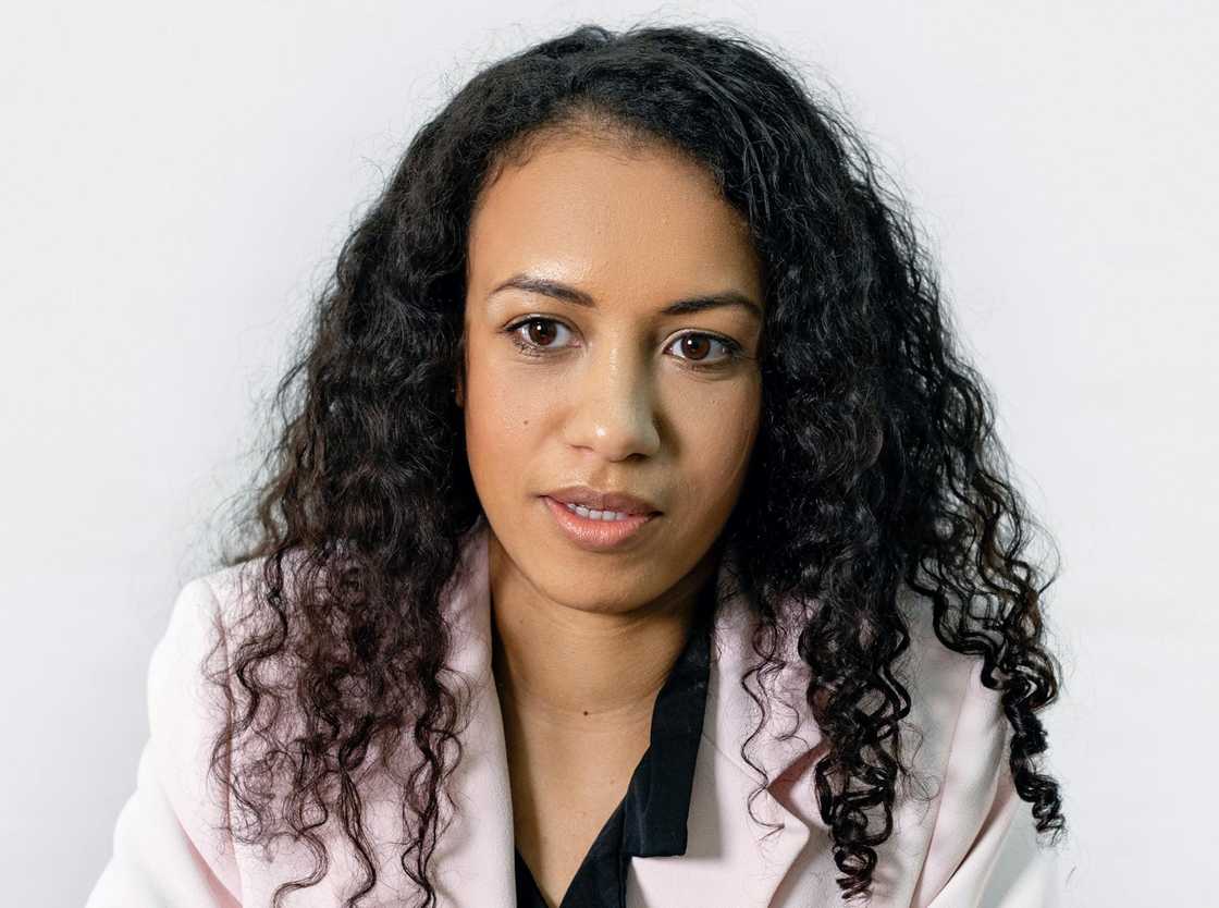 A woman facing the camera against a plain white background. A woman facing the camera against a plain white background.