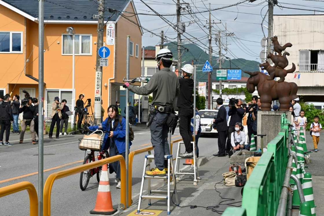 Workers install a barrier to block the sight of Mount Fuji in the town of Fujikawaguchiko Workers install a barrier to block the sight of Mount Fuji in the town of Fujikawaguchiko