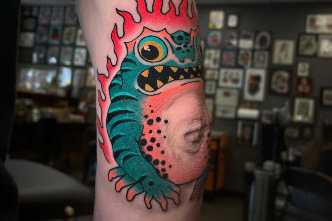 A colourful frog elbow tattoo A colourful frog elbow tattoo