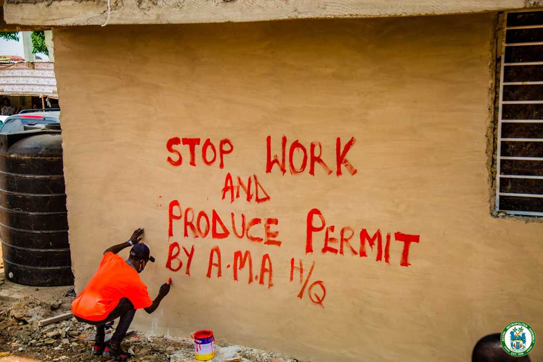 Man writes 'produce permit' on a house