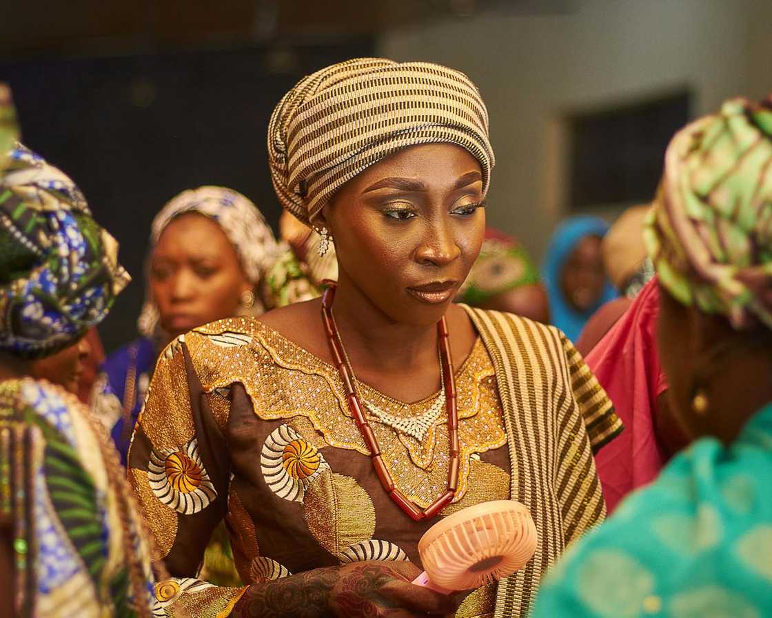 Women in traditional attire attend a gathering. Women in traditional attire attend a gathering.