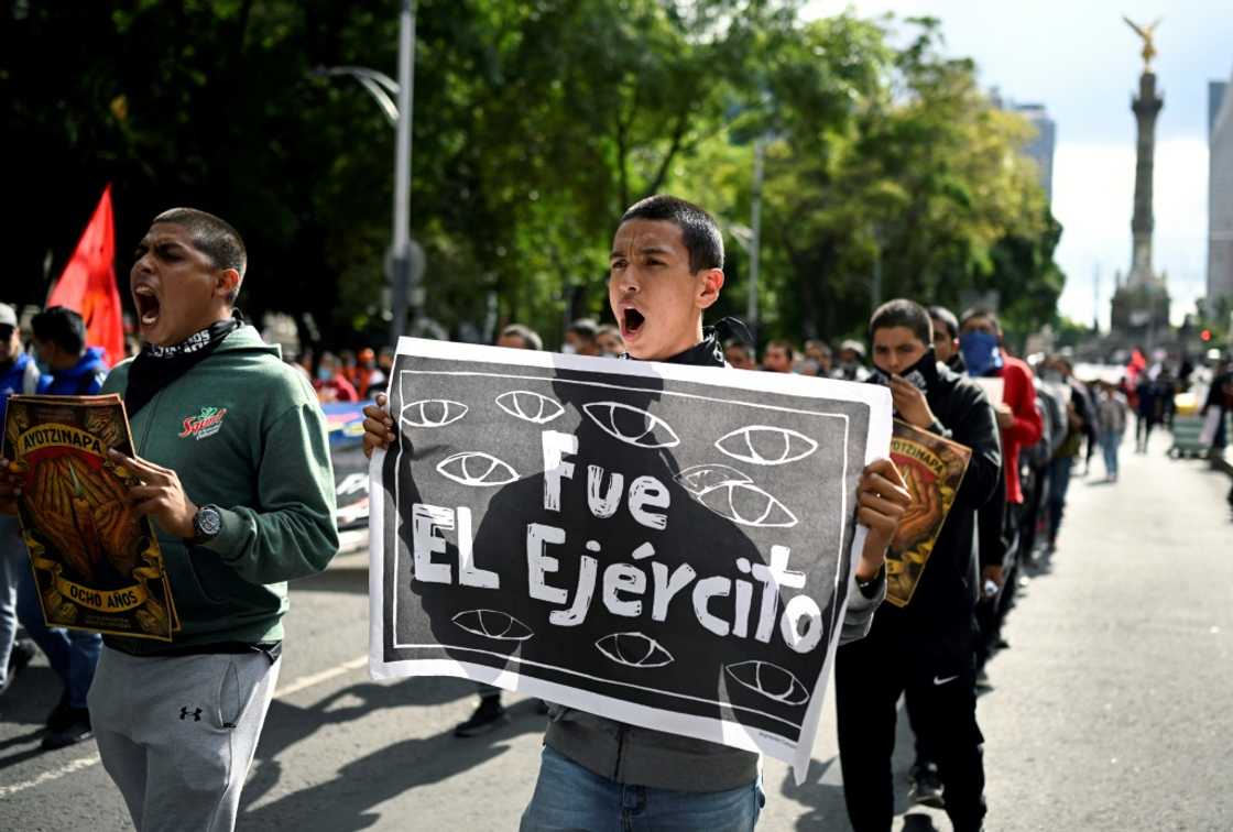 "It was the army" reads a sign carried by a protester at a march in Mexico City to demand justice for 43 students who disappeared in 2014 "It was the army" reads a sign carried by a protester at a march in Mexico City to demand justice for 43 students who disappeared in 2014