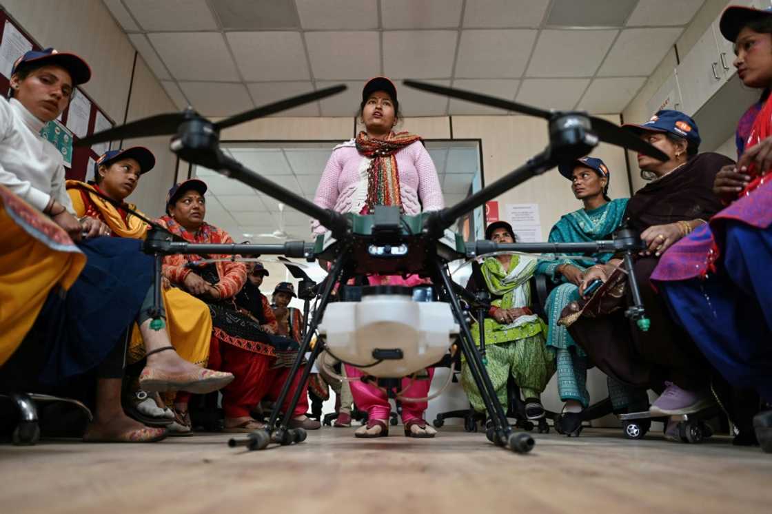 Aspiring drone pilots attend a class under the Indian government-backed "Drone Sister" programme Aspiring drone pilots attend a class under the Indian government-backed "Drone Sister" programme
