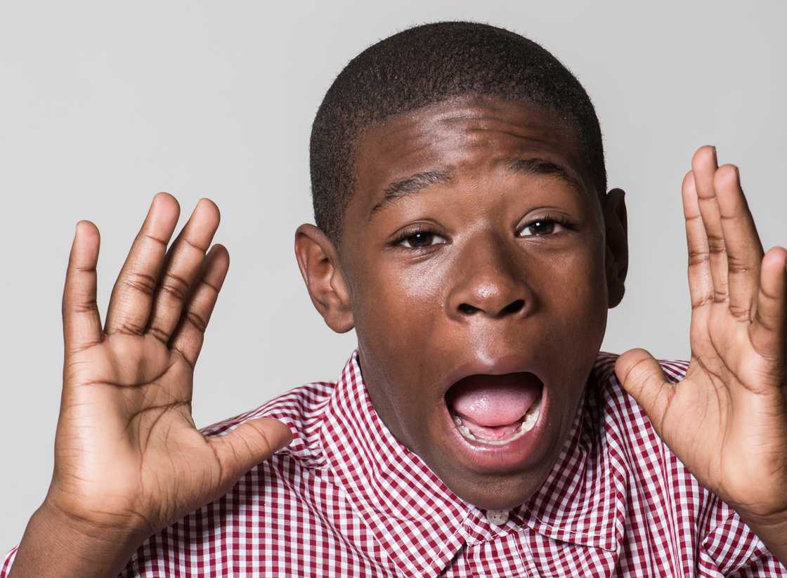 A shocked boy in school uniform