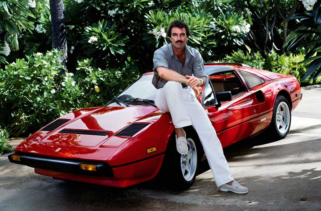 Tom Selleck sitting on a red car Tom Selleck sitting on a red car