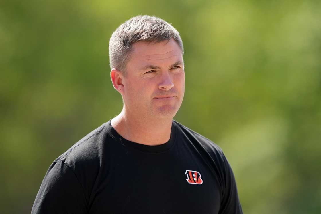 Head coach Zac Taylor walks to the fields during an OTA offseason workout