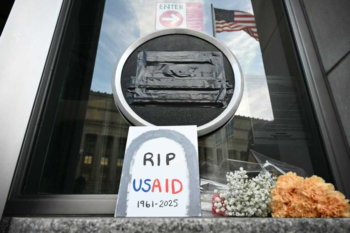 Tributes are placed beneath the covered seal of the US Agency for International Development at USAID headquarters in Washington, after an unprecedented campaign to dismantle the humanitarian agency Tributes are placed beneath the covered seal of the US Agency for International Development at USAID headquarters in Washington, after an unprecedented campaign to dismantle the humanitarian agency