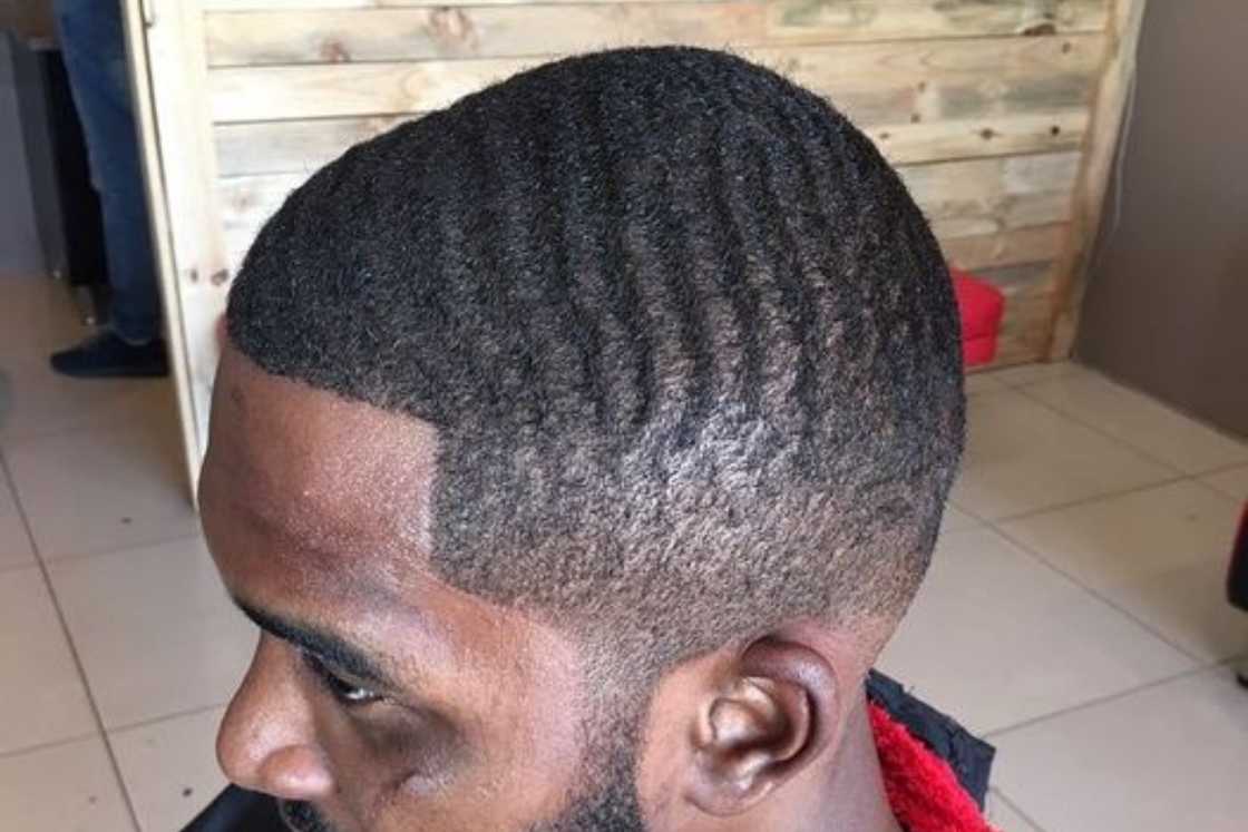 A man is rocking a wavy caeser haircut