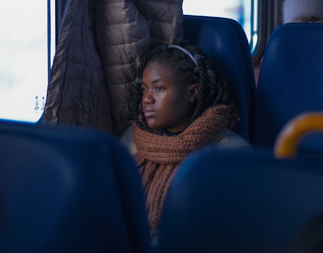 A distressed woman sitting on a train, looking out the window A distressed woman sitting on a train, looking out the window