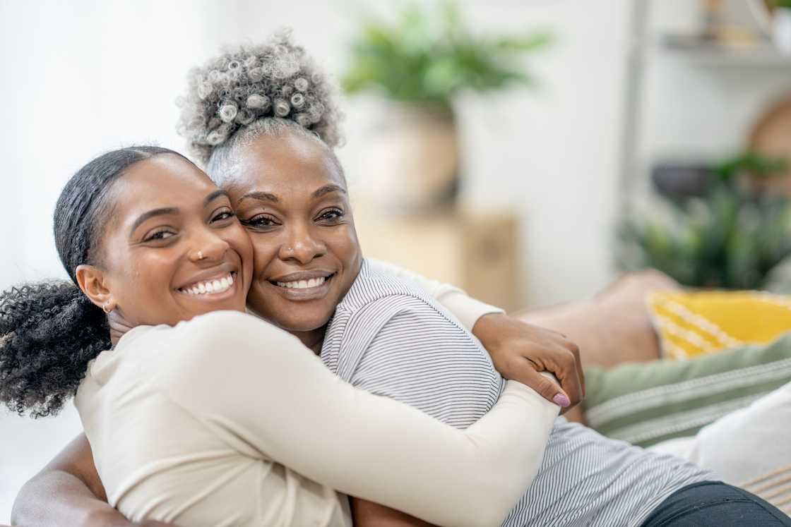 Two woemn are hugging Two woemn are hugging