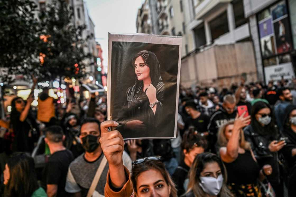 A protester in Istanbul, Turkey holds up a portrait of Mahsa Amini A protester in Istanbul, Turkey holds up a portrait of Mahsa Amini