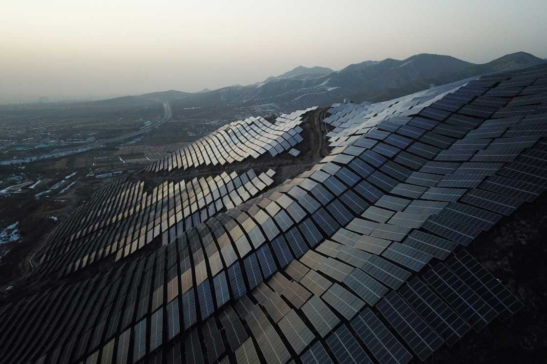 A vast array of solar panels on a hillside in China's northern Hebei province A vast array of solar panels on a hillside in China's northern Hebei province