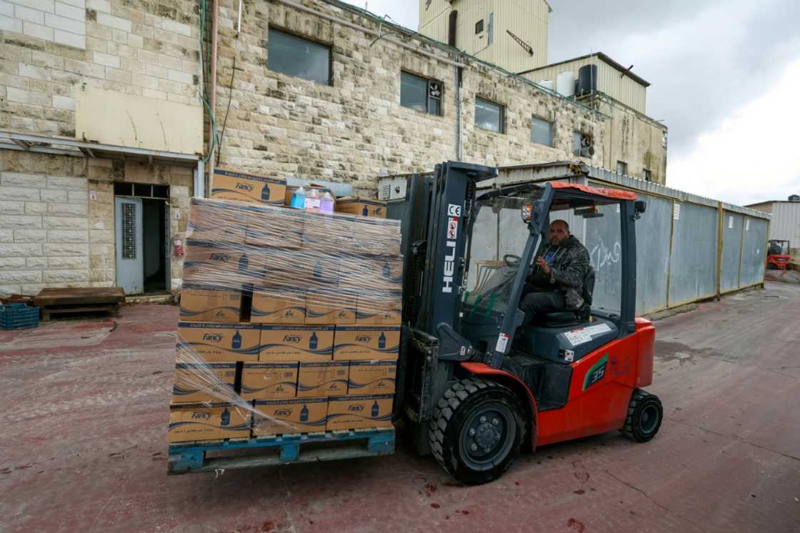 An employee transports boxes at Bishara Jubran's household products and cosmetics factory in the occupied West Bank city of Ramallah, who was able to keep his factory afloat by selling washing powder and other household products An employee transports boxes at Bishara Jubran's household products and cosmetics factory in the occupied West Bank city of Ramallah, who was able to keep his factory afloat by selling washing powder and other household products