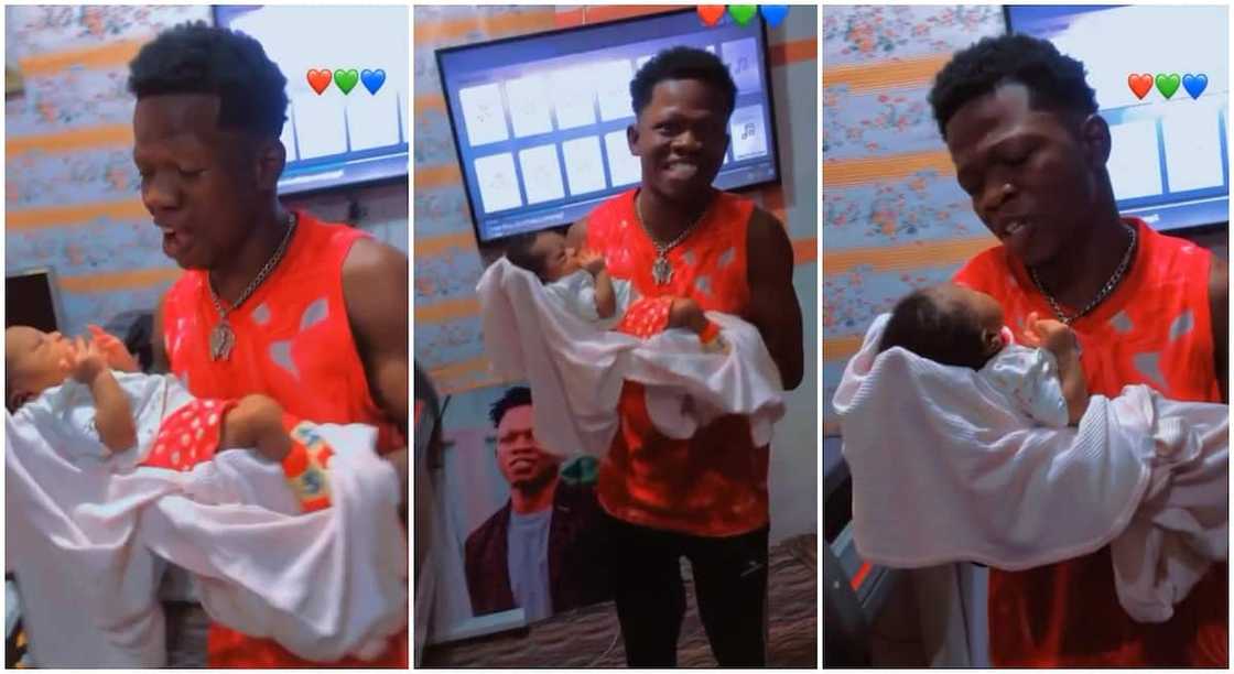 Nigerian man dances while holding his newborn baby.