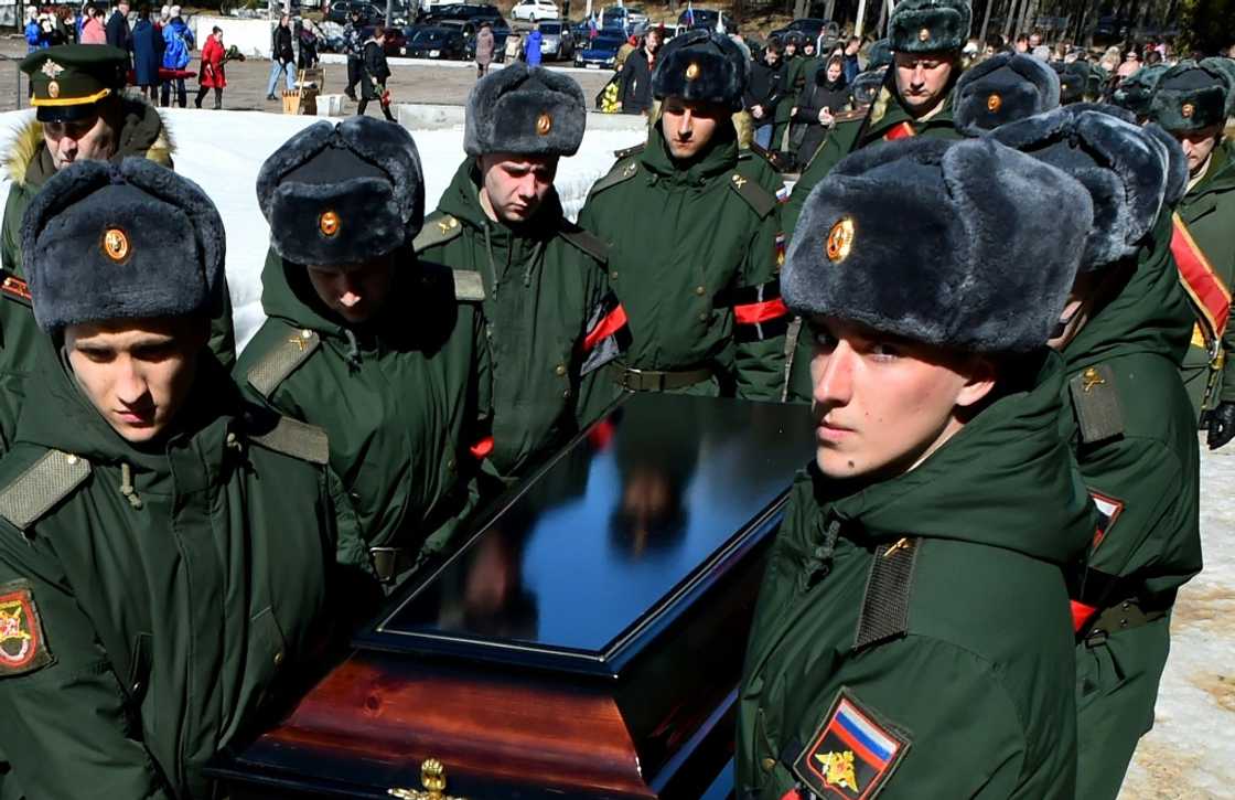 Soldiers carry the coffin of 20-year-old Russian serviceman Nikita Avrov, during his funeral at a church in Luga, some 150 kilometers south of Saint Petersburg, on April 11, 2022