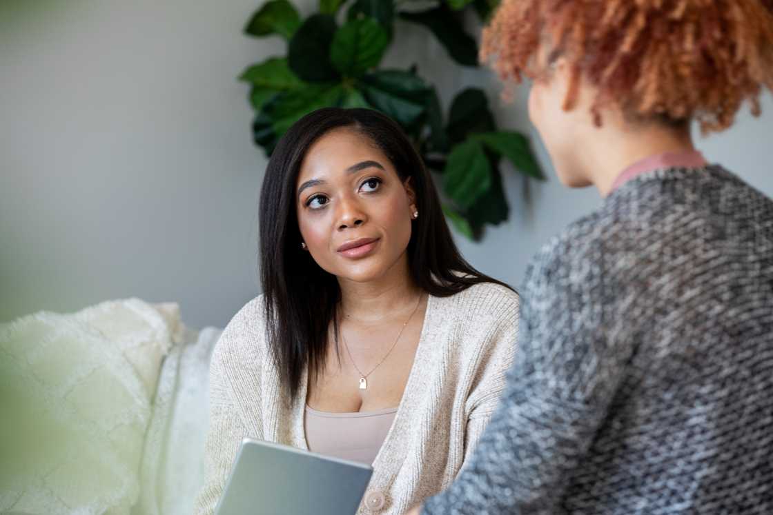 Two women talking indoors