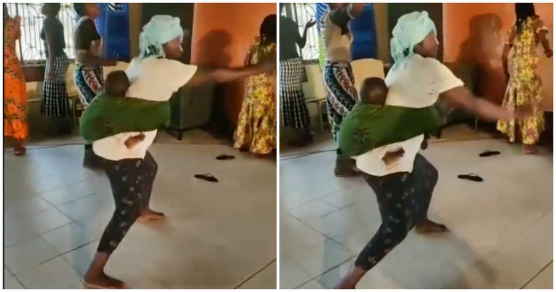 Woman praying with her baby at her back Woman praying with her baby at her back