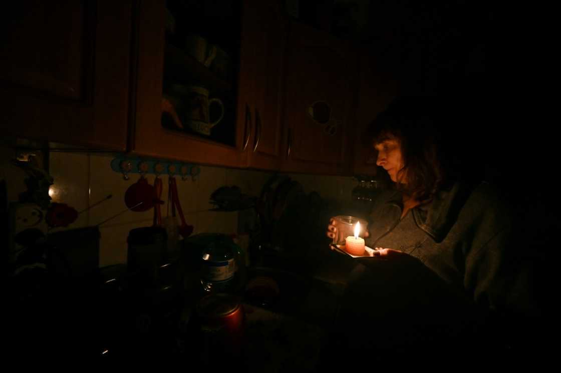 Iren Rozdobudko cooks by candlelight during a power cut Iren Rozdobudko cooks by candlelight during a power cut