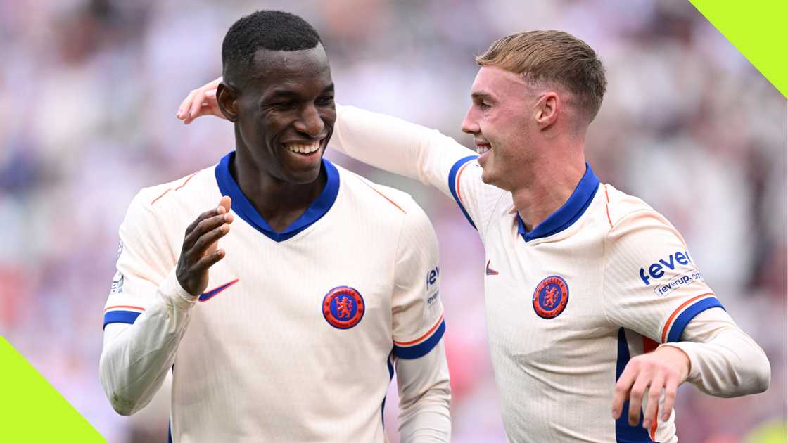 Nicolas Jackson and Cole Palmer celebrate Chelsea's third goal against West Ham.