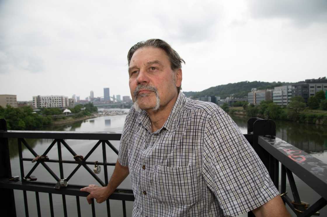 Edward Stankowski, Jr., a former steelworker, stands on the Hot Metal Bridge  above the Monongahela River, a waterway once teeming with iron ore and coal barges for Pittsburgh steel mills