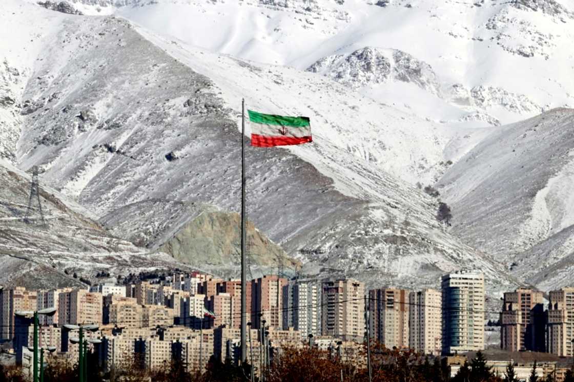 A view of a giant Iranian flag in the capital Tehran with the snow-covered Alborz mountain range in the background on January 18, 2022 A view of a giant Iranian flag in the capital Tehran with the snow-covered Alborz mountain range in the background on January 18, 2022