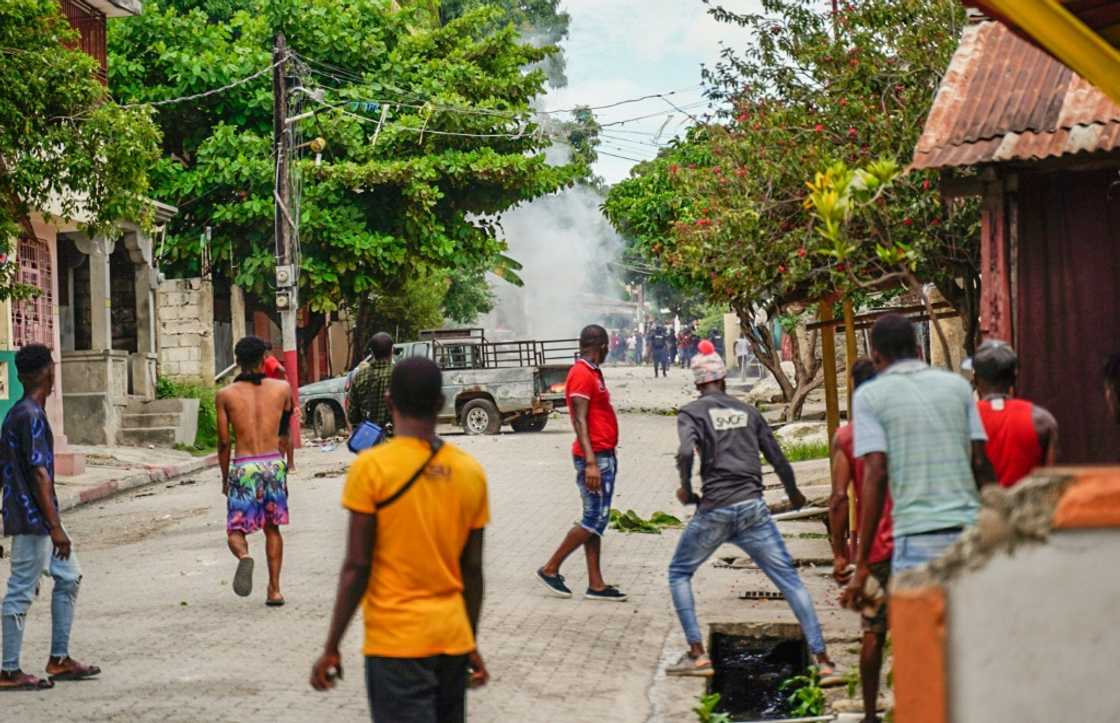 Haitians throw stones at the police during a violent demonstration in August 2022; they were protesting the rising cost of living and insecurity as the country, the poorest in the Western hemisphere, is mired in gang violence and political turmoil Haitians throw stones at the police during a violent demonstration in August 2022; they were protesting the rising cost of living and insecurity as the country, the poorest in the Western hemisphere, is mired in gang violence and political turmoil