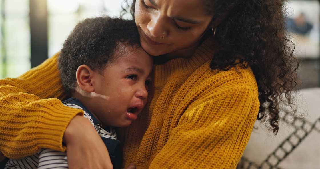 A mother comforting her crying child