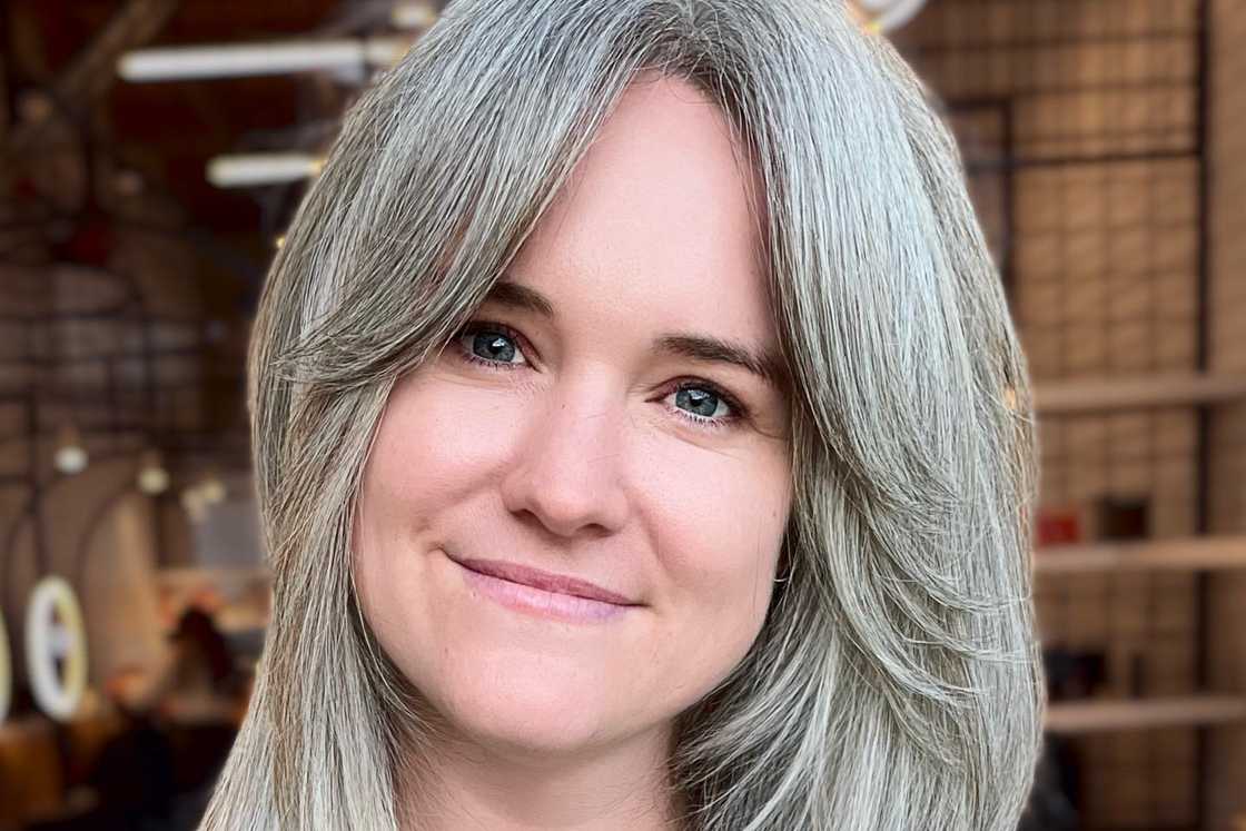 A ladys wears a gorgeous thick grey hair with a curtain fringe A ladys wears a gorgeous thick grey hair with a curtain fringe