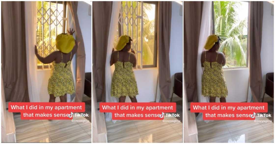 A lady opens her window A lady opens her window