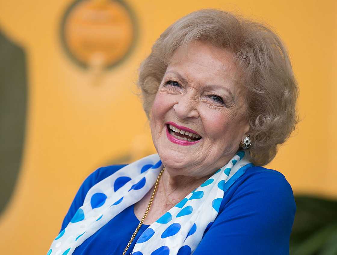 Betty White in a blue and white attire smiling Betty White in a blue and white attire smiling