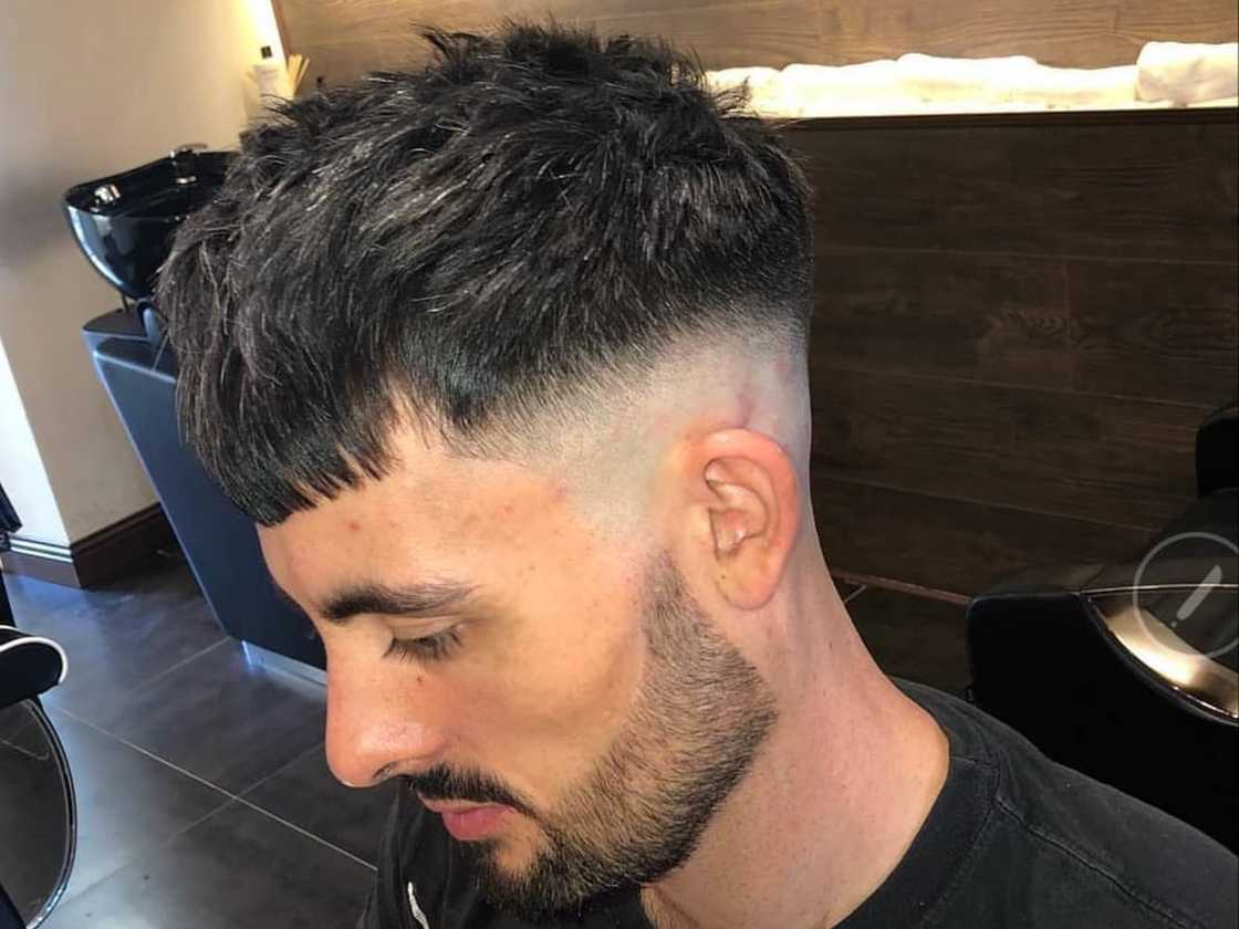 Young man with a mid-fade crop with fringe haircut