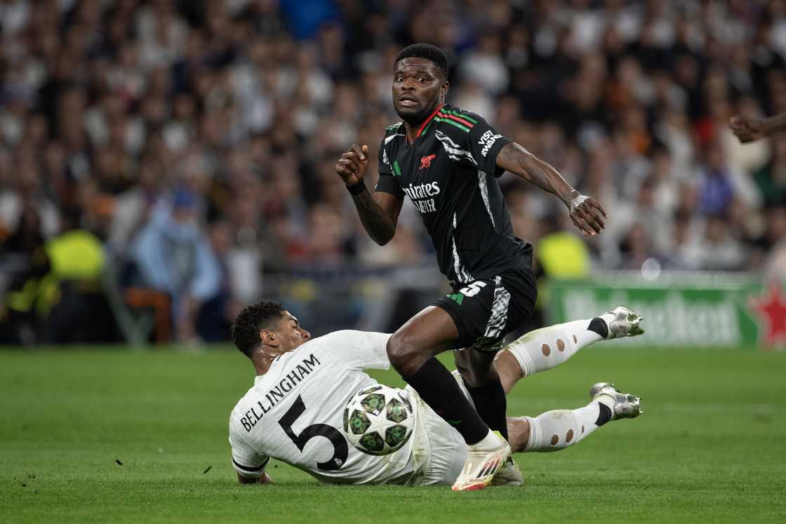Ghana's Thomas Partey of Arsenal is challenged by Jude Bellingham during the UEFA Champions League 2024/25 Quarter Final Second Leg match between Real Madrid C.F. and Arsenal FC at Estadio Santiago Bernabeu on April 16, 2025 in Madrid, Spain Ghana's Thomas Partey of Arsenal is challenged by Jude Bellingham during the UEFA Champions League 2024/25 Quarter Final Second Leg match between Real Madrid C.F. and Arsenal FC at Estadio Santiago Bernabeu on April 16, 2025 in Madrid, Spain