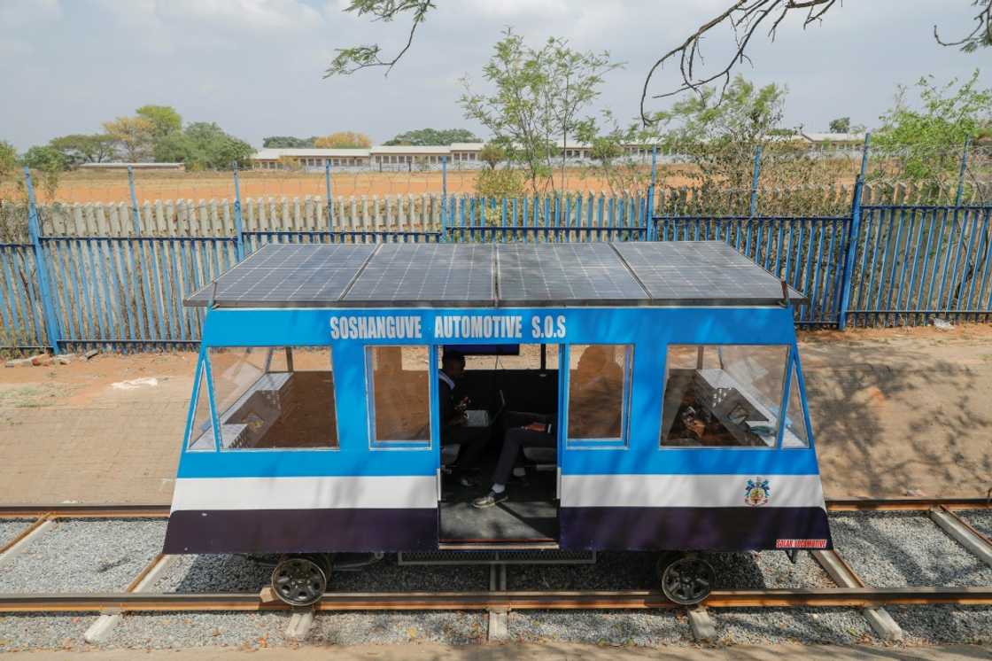 Photovoltaic panels fitted on rooftop, the blue-and-white train moves on an 18-metre long testing track in Soshanguve township