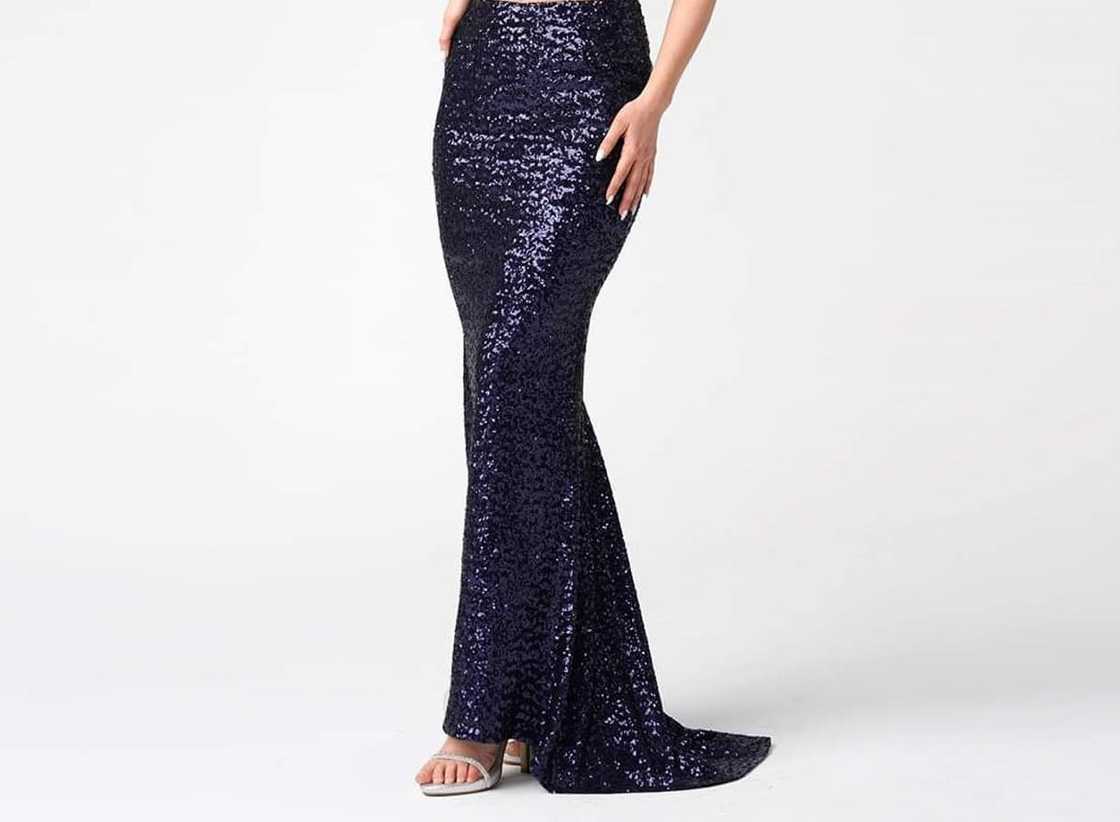 A woman is wearing a glittery mermaid skirt A woman is wearing a glittery mermaid skirt