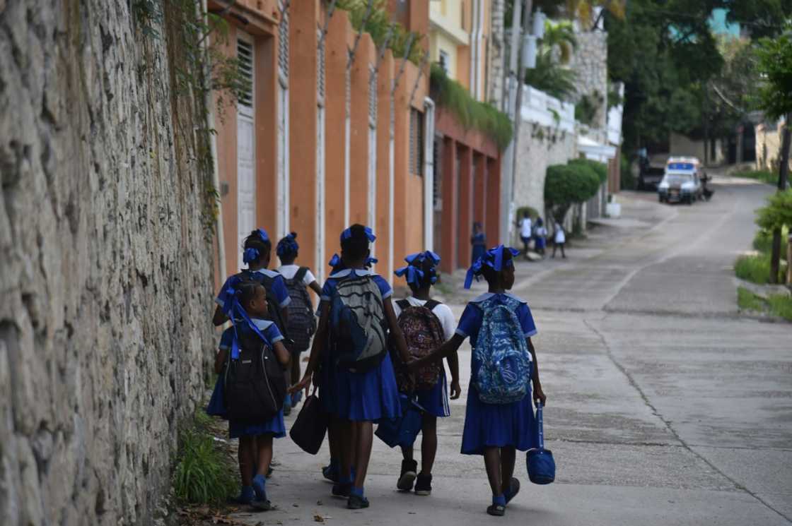 Children return home from school in the Haitian capital of Port-au-Prince in November 2018 Children return home from school in the Haitian capital of Port-au-Prince in November 2018