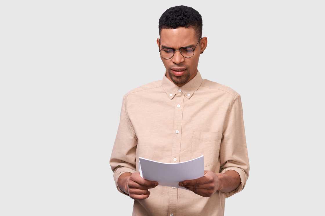 A worried man reading a document