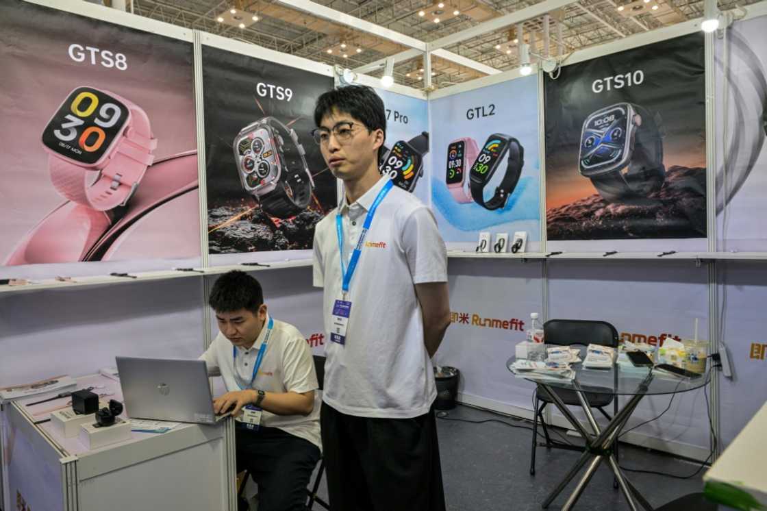 Han Zhongkai (C), 27, employee at his stand during the Ningbo Cross-Border E-commerce Expo Fair in Ningbo Han Zhongkai (C), 27, employee at his stand during the Ningbo Cross-Border E-commerce Expo Fair in Ningbo