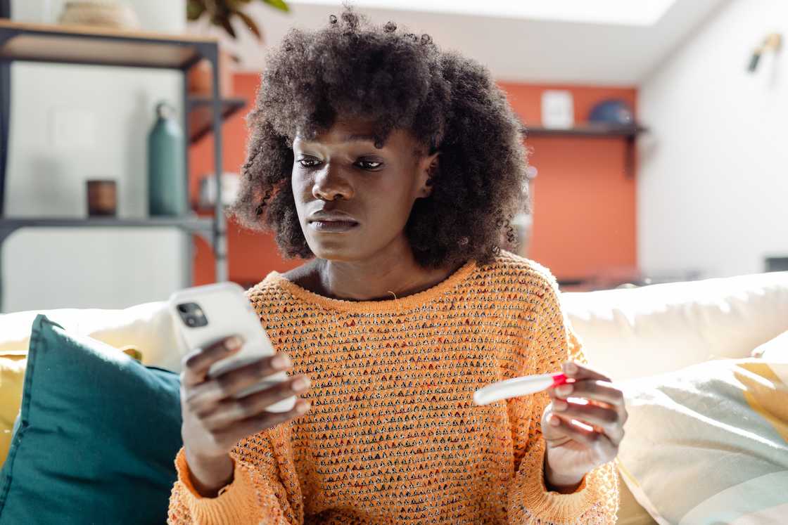 A lady holds a pregnancy test