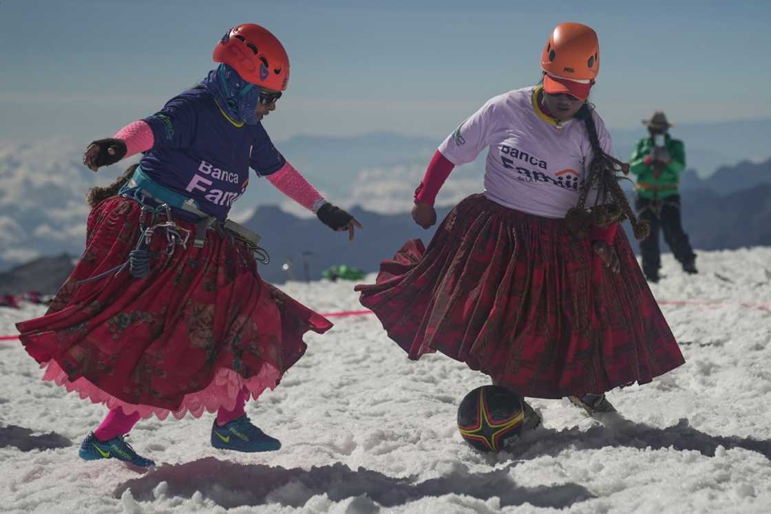 Cecilia Llusco (left) and Senobia Llusco vie for the ball in a high altitude football match after climbing the imposing 6.088-metre Huayna Potosi mountain Cecilia Llusco (left) and Senobia Llusco vie for the ball in a high altitude football match after climbing the imposing 6.088-metre Huayna Potosi mountain